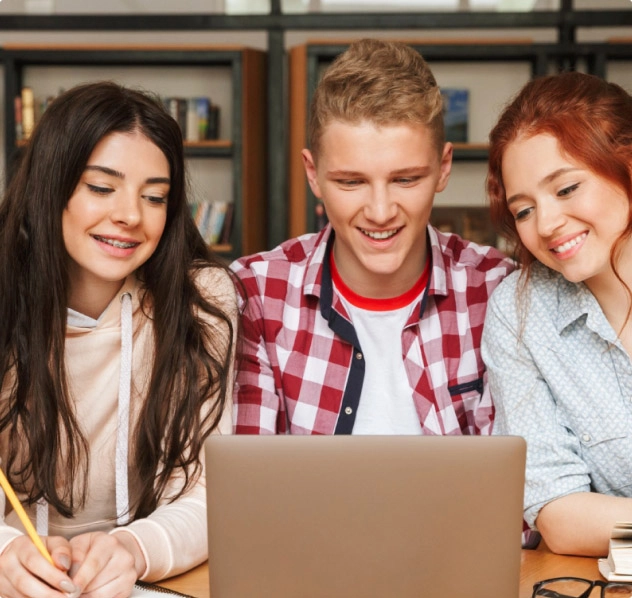 Group of happy students with a laptop